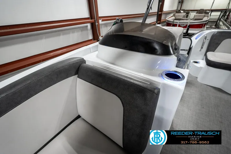 Slide: The Image of 2019 Crest Calypso 190 boat interior with seating and console, Reeder-Trausch Marine logo visible. - 23