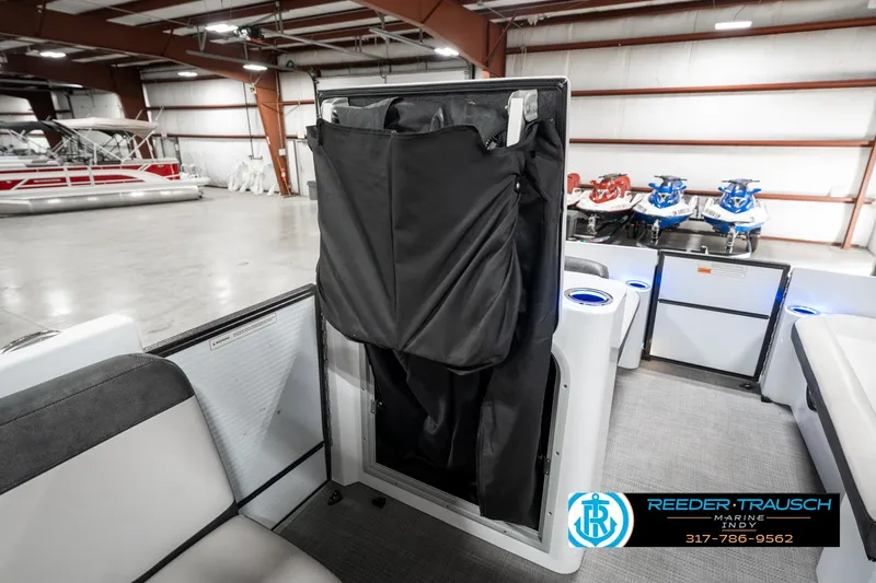 Slide: The Image of 2019 Crest Calypso 190 boat interior with storage compartment in a showroom. - 26