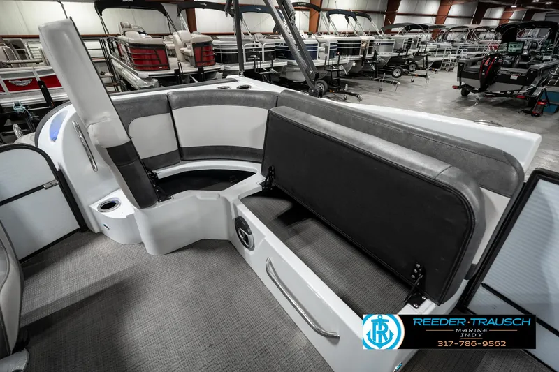 Slide: The Image of 2019 Crest Calypso 190 boat interior with gray seating and storage compartment. - 28