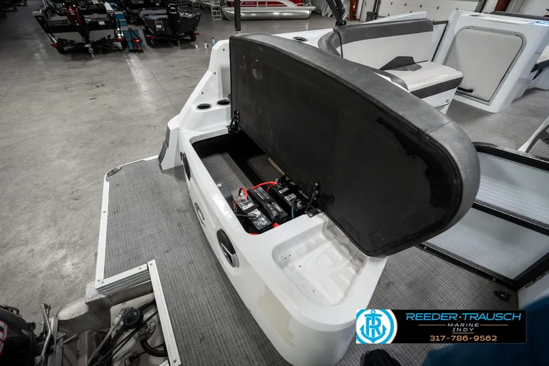 Slide: The Image of 2019 Crest Calypso 190 boat with open storage compartment in a showroom. - 30