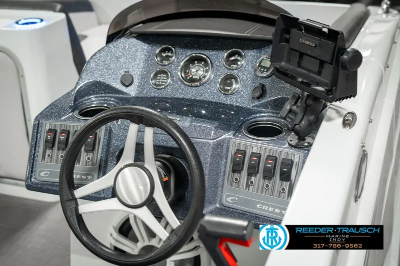 Slide: The Image of 2019 Crest Calypso 190 boat dashboard with steering wheel and control panel. - 31