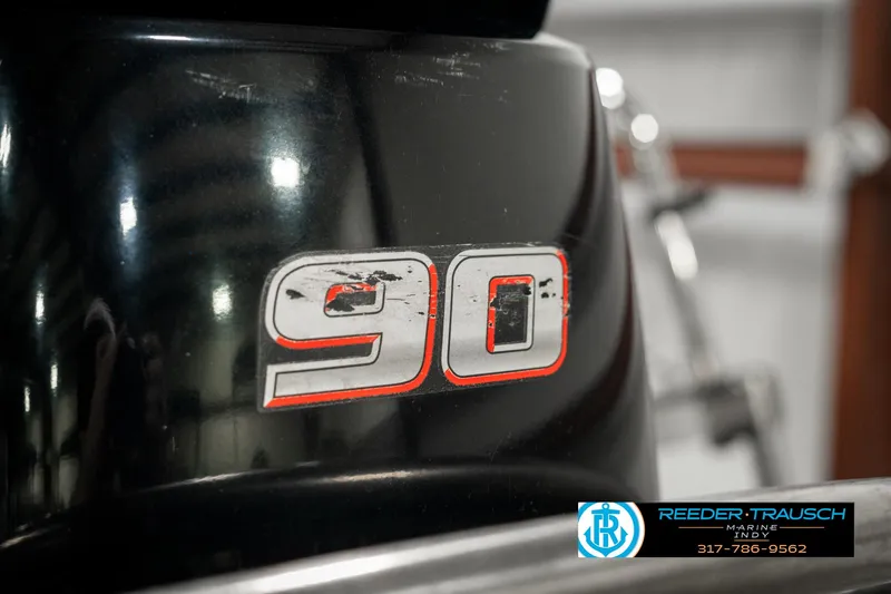 Slide: The Image of Close-up of a 2019 Crest Calypso 190 boat engine with "90" decal. - 47