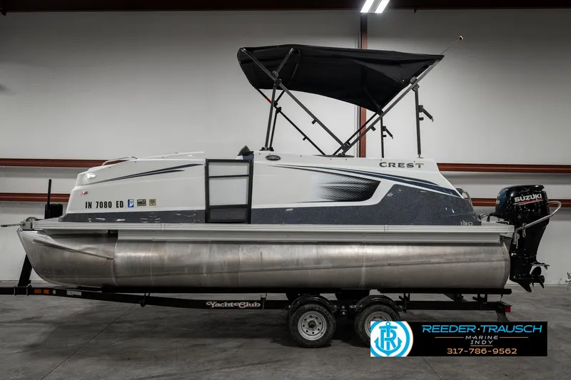 Slide: The Image of 2019 Crest Calypso 190 pontoon boat with canopy in indoor showroom. - 5