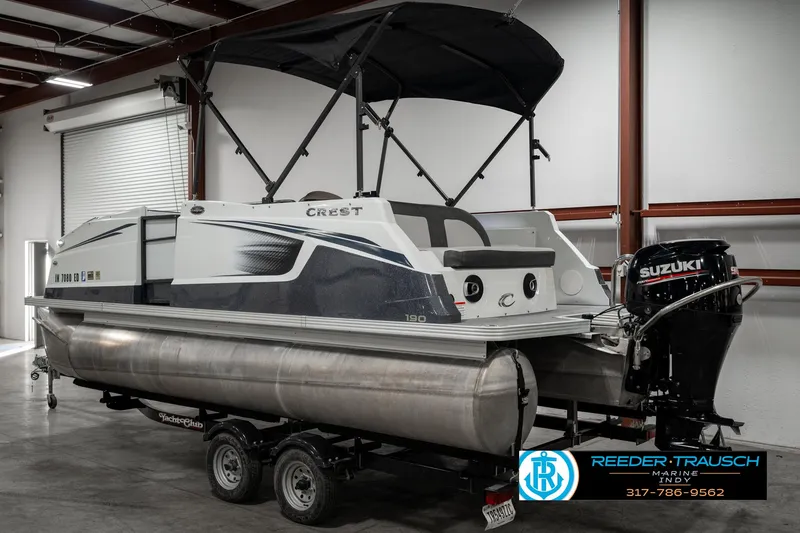 Slide: The Image of 2019 Crest Calypso 190 pontoon boat with Suzuki outboard motor in a warehouse. - 6