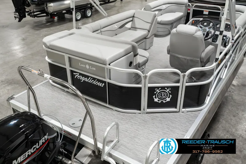 Slide: The Image of 2023 Bennington 20 SVL pontoon boat with gray seating and Mercury engine in showroom. - 11
