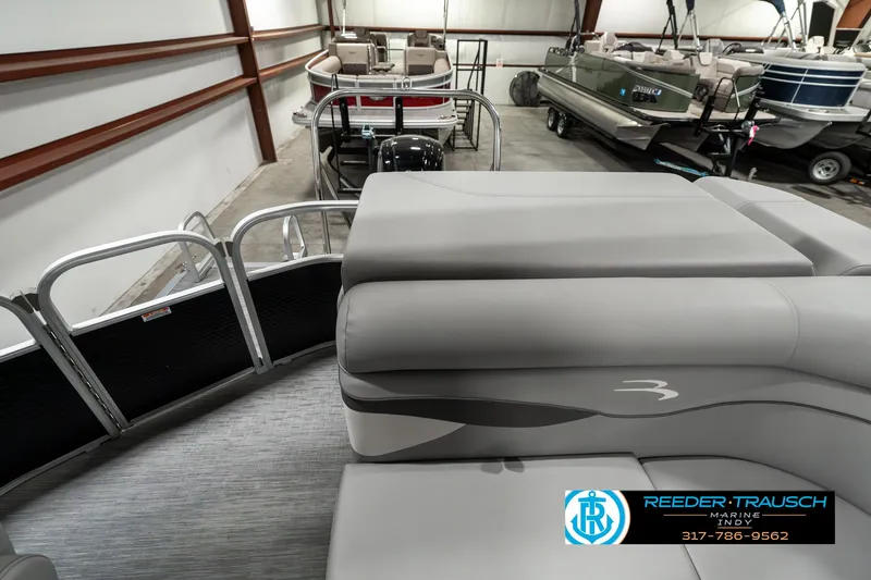 Slide: The Image of 2023 Bennington 20 SVL pontoon boat interior with gray seating in a showroom. - 15