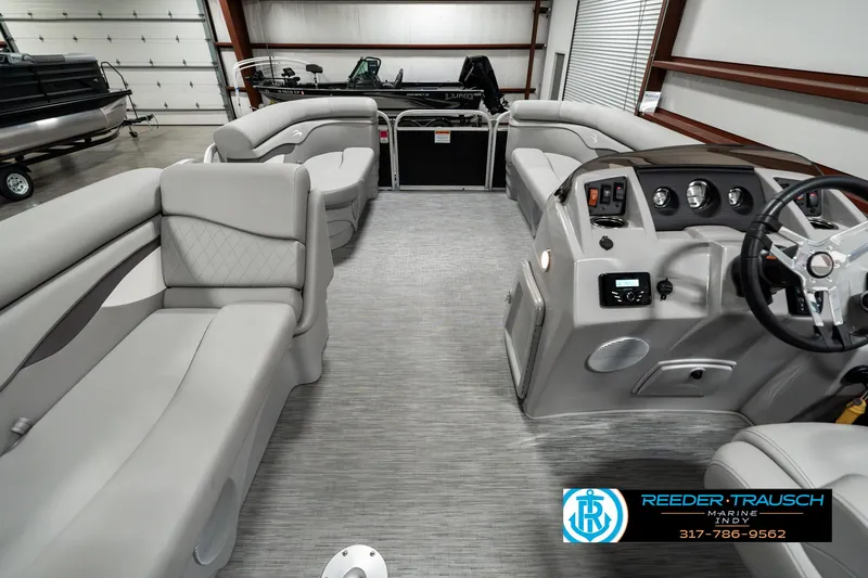 Slide: The Image of 2023 Bennington 20 SVL pontoon boat interior with gray seating and modern dashboard. - 17