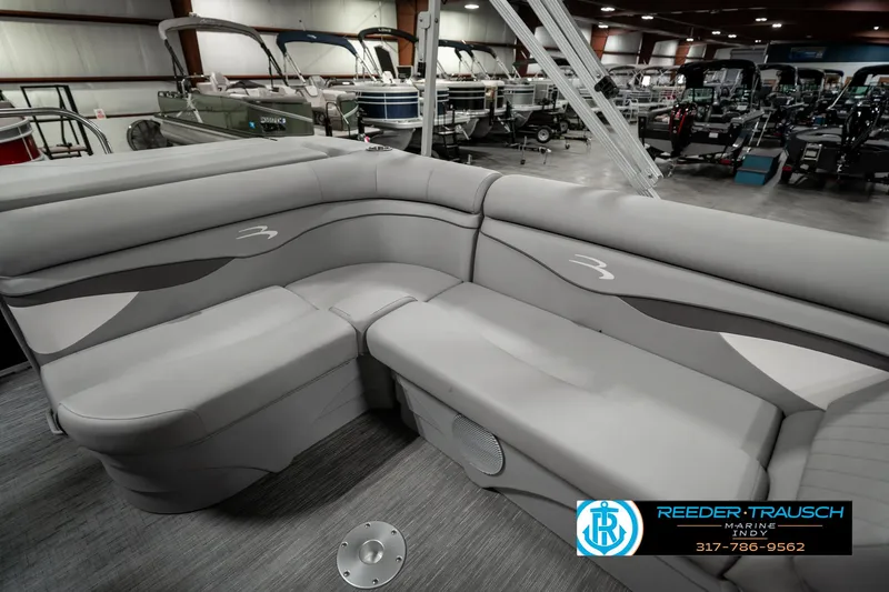 Slide: The Image of 2023 Bennington 20 SVL pontoon boat interior with gray seating in showroom. - 20
