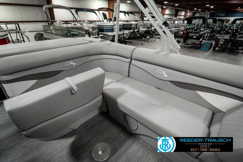 Slide: The Image of 2023 Bennington 20 SVL pontoon boat interior with gray seating in showroom. - 21