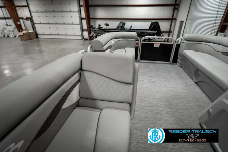 Slide: The Image of 2023 Bennington 20 SVL pontoon boat interior with gray seating in a showroom. - 23