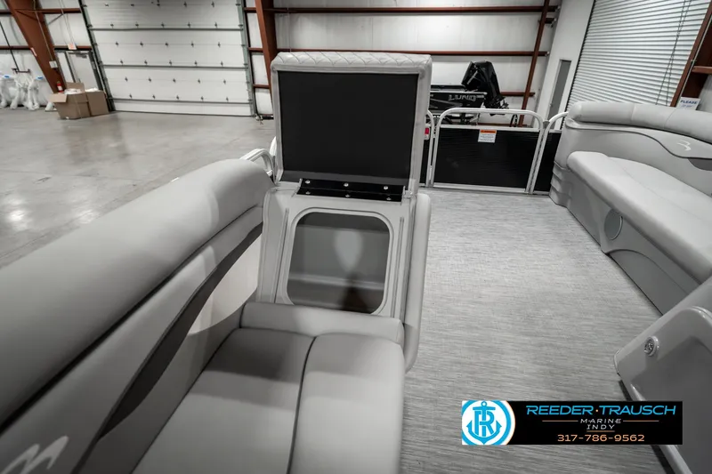 Slide: The Image of 2023 Bennington 20 SVL pontoon boat interior with gray seating and storage compartment. - 24