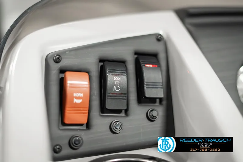 Slide: The Image of Control panel of 2023 Bennington 20 SVL boat with switches for horn and dock lights. - 29