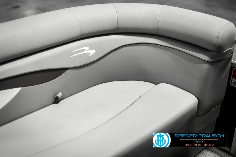Slide: The Image of 2023 Bennington 20 SVL boat interior with sleek gray seating and logo detail. - 36