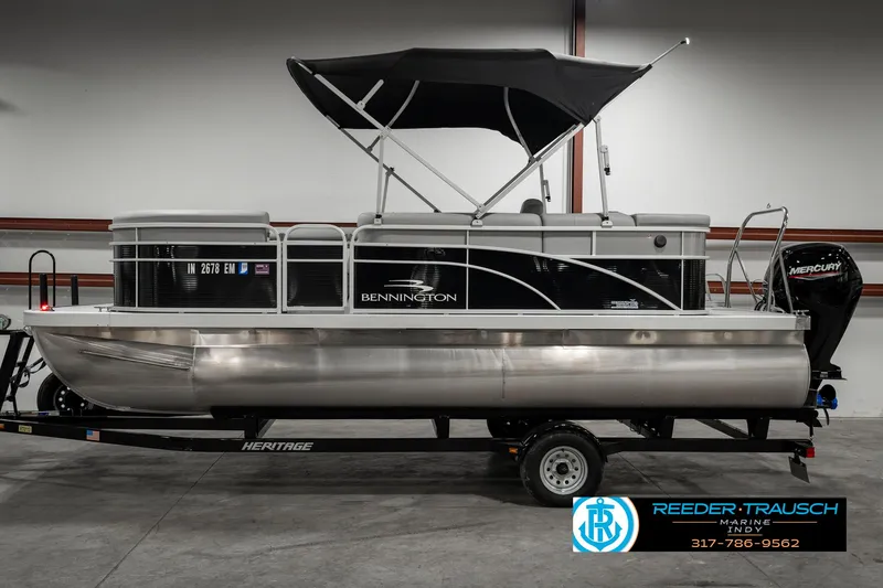 Slide: The Image of 2023 Bennington 20 SVL pontoon boat with black canopy on trailer. - 5