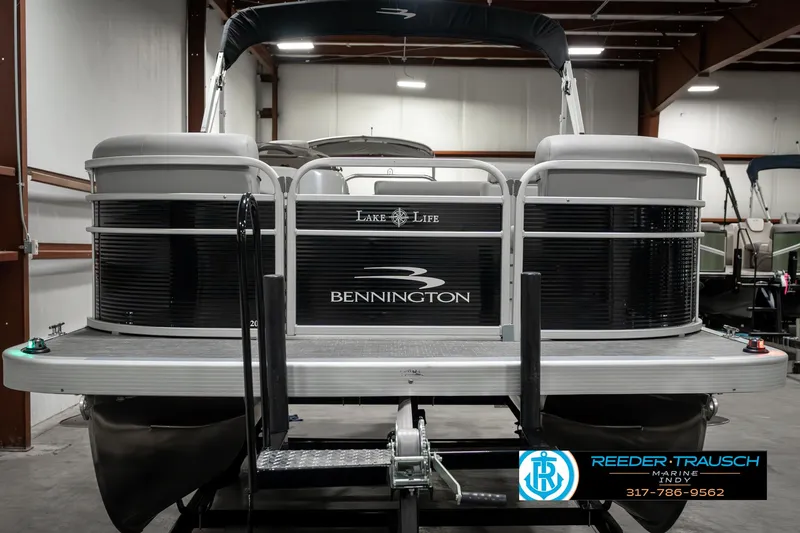 Slide: The Image of 2023 Bennington 20 SVL pontoon boat in showroom, rear view. - 8