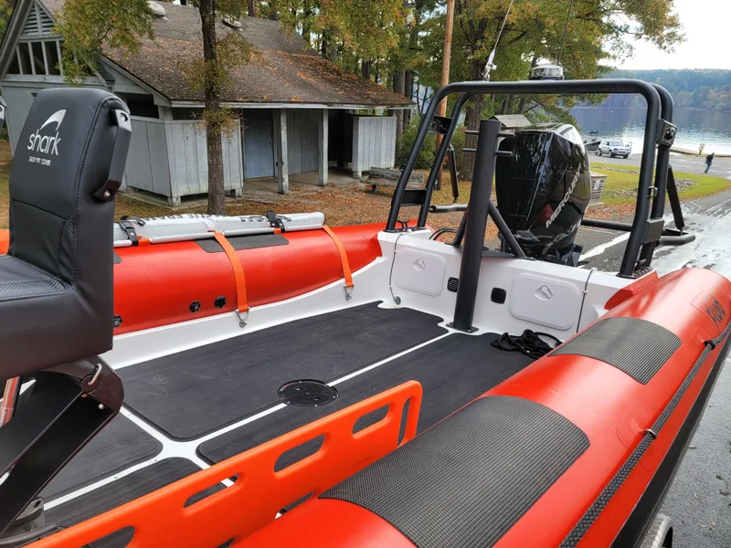 Slide: The Image of 2025 Fluid Watercraft SAR 23 boat seats with Shark branding, outdoor setting. - 1