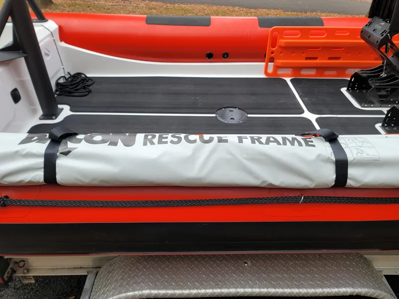 Slide: The Image of Fluid Watercraft SAR 23 boat, 2025 model, with vibrant orange and black design. - 2