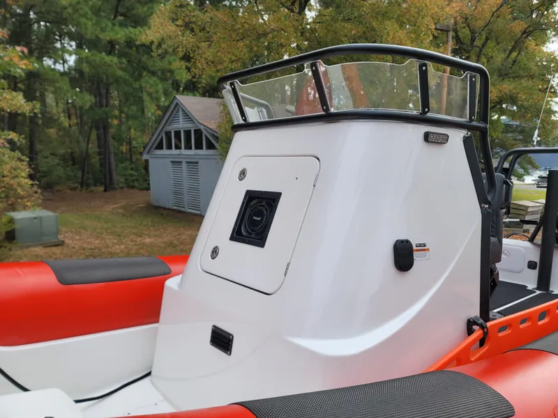 Slide: The Image of Red and black Fluid Watercraft SAR 23 boat, 2025 model, in a wooded area. - 4