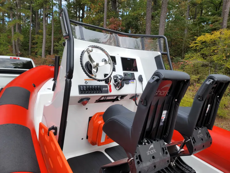 Slide: The Image of Fluid Watercraft SAR 23, 2025 model, red and white design, outdoor setting. - 5