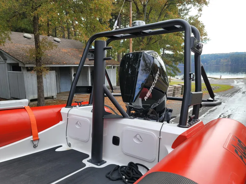 Slide: The Image of 2025 Fluid Watercraft SAR 23 boat on trailer, vibrant orange and black design. - 7