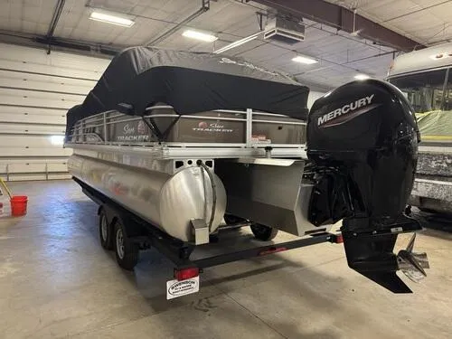 Slide: The Image of 2023 Sun Tracker SportFish 22 XP3 pontoon boat with Mercury engine in a garage. - 16