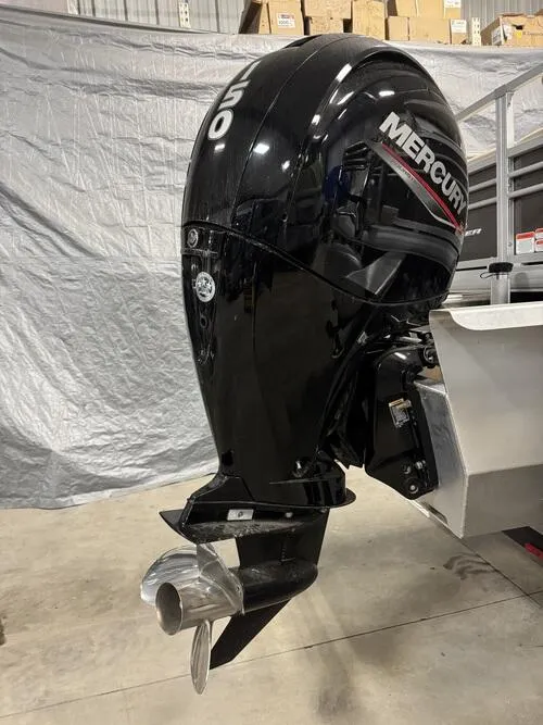 Slide: The Image of 2023 Sun Tracker SportFish 22 XP3 with Mercury outboard motor in a showroom. - 5