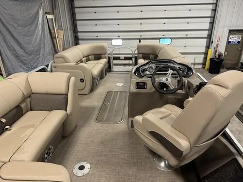 Slide: The Image of 2023 Sun Tracker SportFish 22 XP3 pontoon boat interior with beige seating and steering console. - 7