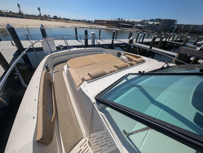 Slide: The Image of 2019 Sea Ray Sundancer 320 yacht with spacious deck and seating at marina. - 11