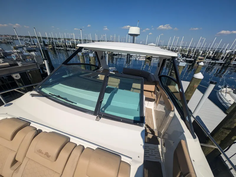 Slide: The Image of 2019 Sea Ray Sundancer 320 docked at marina, clear sky, calm waters. - 12