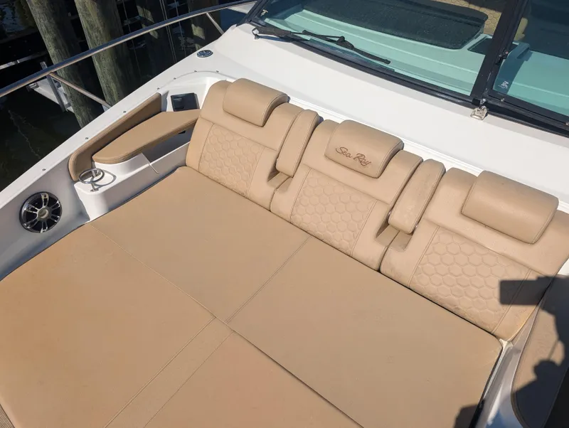 Slide: The Image of 2019 Sea Ray Sundancer 320 boat with beige cushioned seating area. - 14