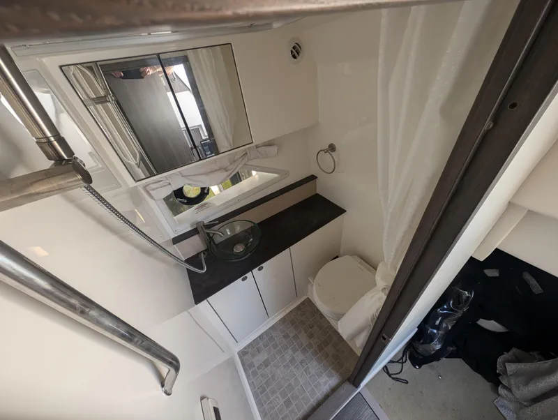 Slide: The Image of 2019 Sea Ray Sundancer 320 bathroom with modern fixtures and compact design. - 21