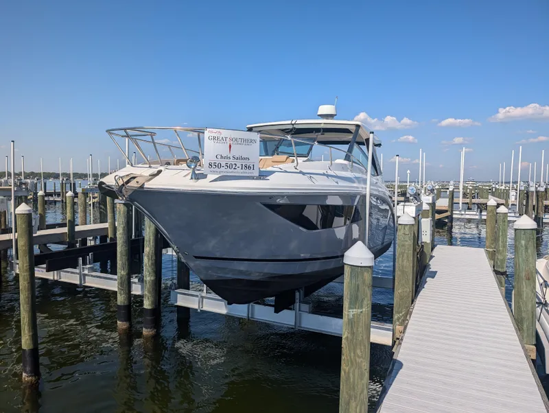 Slide: The Image of 2019 Sea Ray Sundancer 320 docked at marina under clear blue sky. - 22