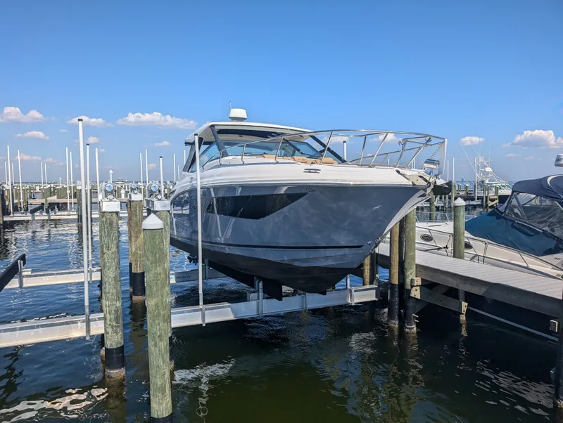 Slide: The Image of 2019 Sea Ray Sundancer 320 docked at marina under clear blue sky. - 25
