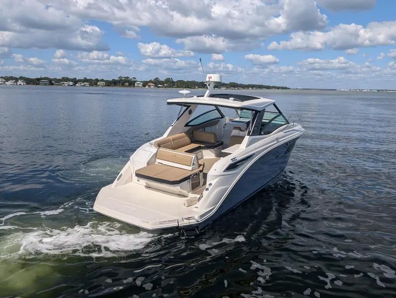 Slide: The Image of 2019 Sea Ray Sundancer 320 cruising on a calm lake under a partly cloudy sky. - 3