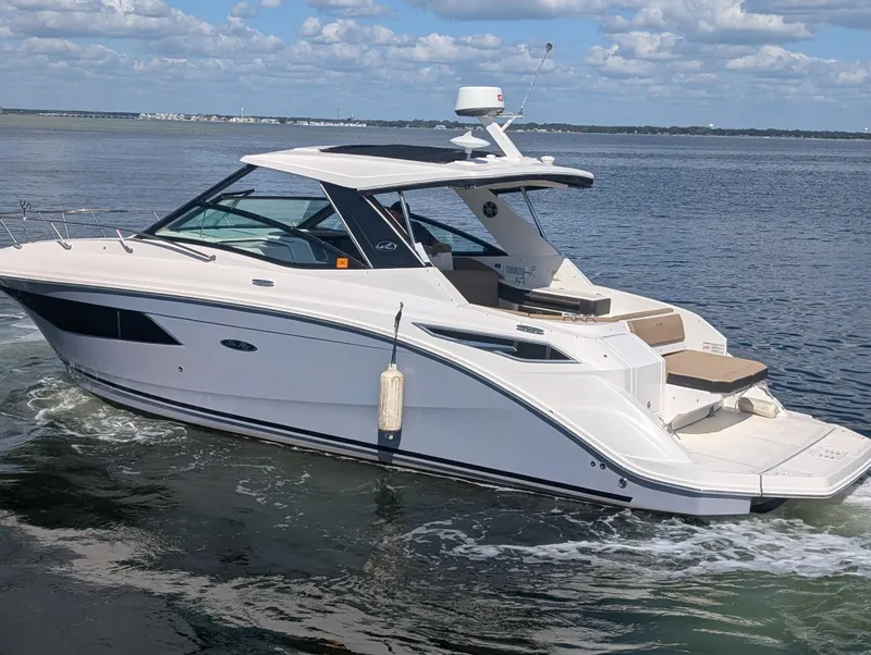 Slide: The Image of 2019 Sea Ray Sundancer 320 cruising on open water under a clear sky. - 4