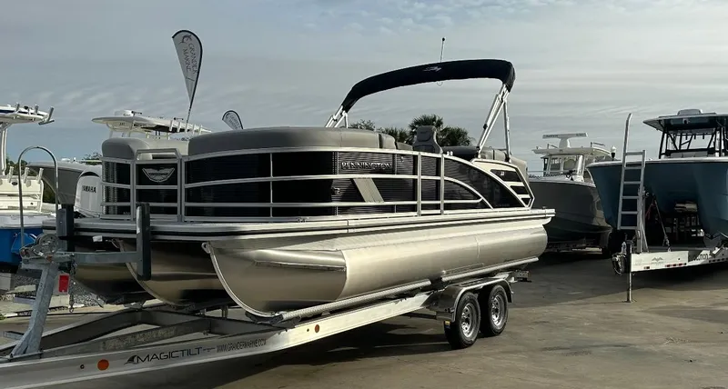 Slide: The Image of 2025 Bennington 22MFB Quad Bench pontoon boat on trailer at marina. - 1