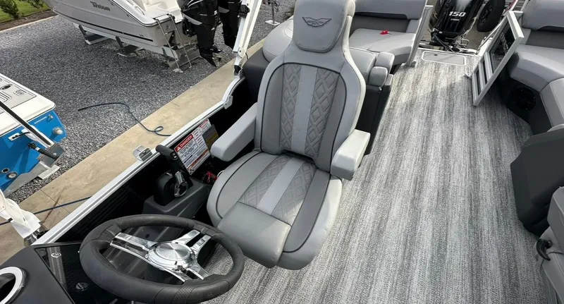 Slide: The Image of 2025 Bennington 22MFB Quad Bench boat interior with steering wheel and seating. - 10