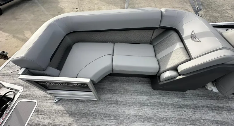 Slide: The Image of 2025 Bennington 22MFB Quad Bench with gray upholstery and sleek design. - 12