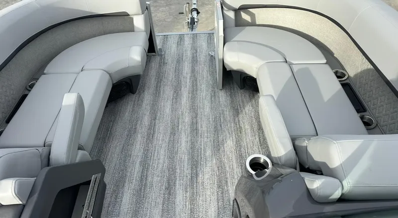 Slide: The Image of 2025 Bennington 22MFB Quad Bench interior with gray seating and carpeted flooring. - 14