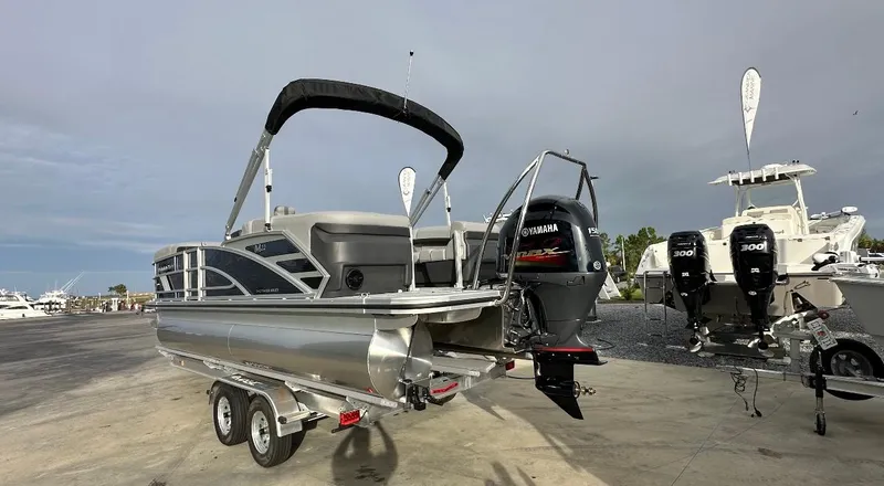 Slide: The Image of 2025 Bennington 22MFB Quad Bench pontoon boat with Yamaha outboard motor on trailer. - 3