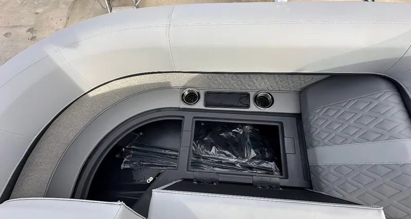 Slide: The Image of 2025 Bennington 22MFB Quad Bench interior with storage and cup holders. - 5