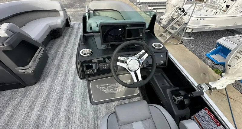Slide: The Image of 2025 Bennington 22MFB Quad Bench boat interior with modern helm and seating. - 9