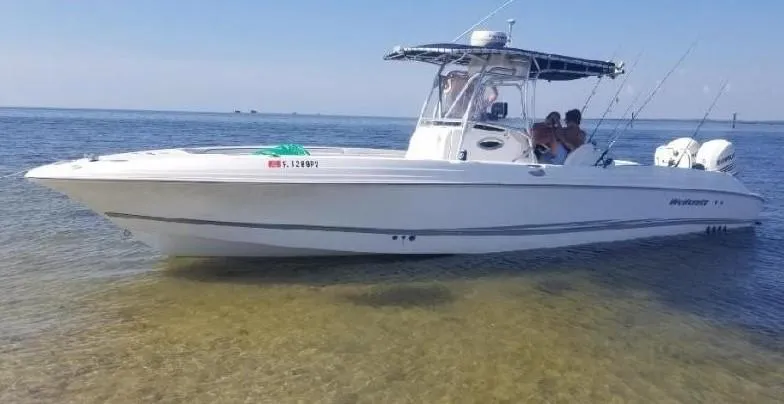 Slide: The Image of 2002 Wellcraft 32 Scarab Sport boat on calm water, side view. - 7