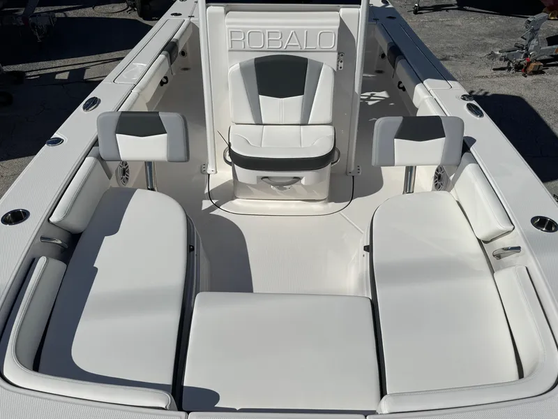 Slide: The Image of 2024 Robalo 246 Cayman boat interior with white seating and sleek design. - 14