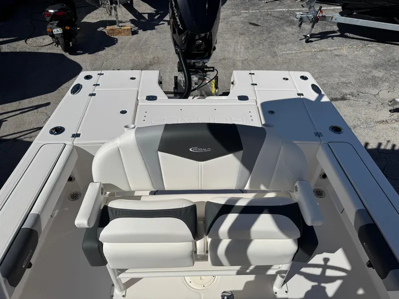 Slide: The Image of 2024 Robalo 246 Cayman boat interior with seating and motor view. - 18