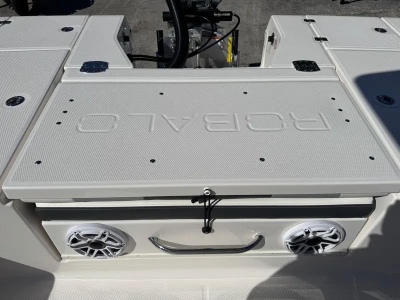 Slide: The Image of 2024 Robalo 246 Cayman boat deck with speakers and storage compartment. - 25