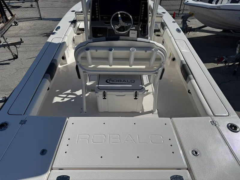 Slide: The Image of 2024 Robalo 246 Cayman boat interior with steering console and seating. - 5