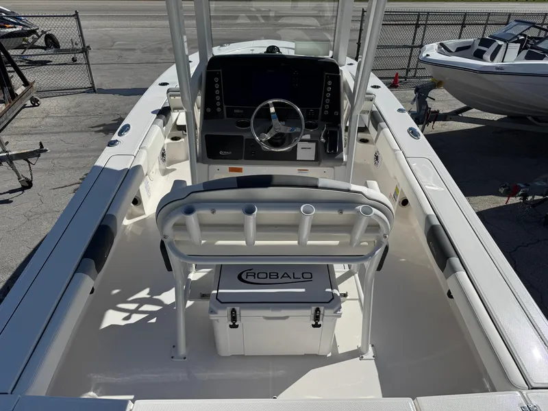 Slide: The Image of 2024 Robalo 246 Cayman boat interior with steering console and seating. - 6