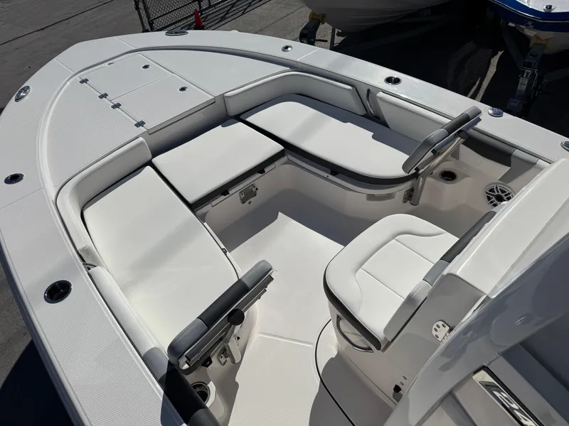Slide: The Image of 2024 Robalo 246 Cayman boat interior with white seating and steering console. - 9