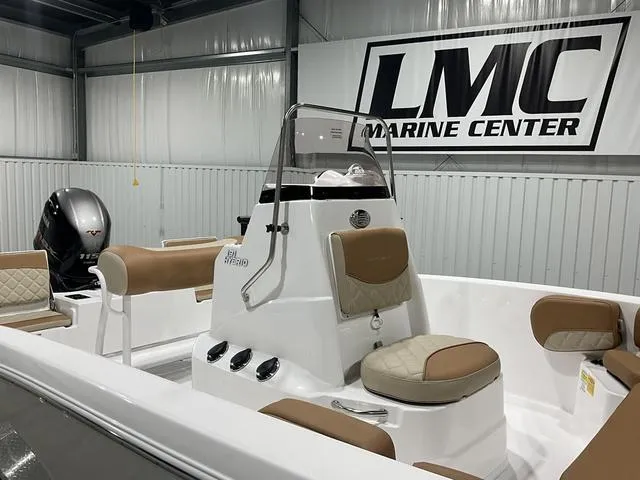 Slide: The Image of 2025 NauticStar 191 Hybrid boat at LMC Marine Center, featuring tan seating and modern design. - 10